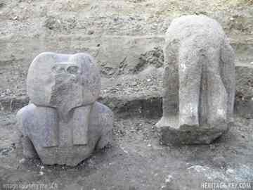The two fragments recently uncovered at the mortuary temple of Amenhotep III in Luxor. On the left is the head of the baboon god, Hapi and on the right are the legs of another red granite statue.