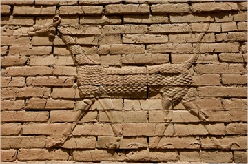 A bas-relief of the Babylon god Marduk adorns a wall.
