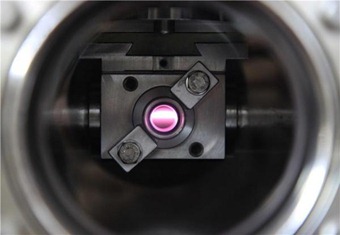 The circularly polarized ultraviolet light (UV-CPL) beam on the DESIRS beamline at the SOLEIL synchrotron facility, shown as it passes through a gas filter filled with xenon. (Credit: © Thomas Lannes)