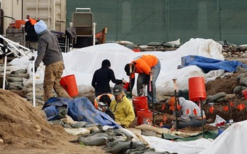 An archeological team was brought in to exhume the bones of early L.A. settlers recently uncovered by construction workers in the former cemetery of La Placita church. The excavation has sparked criticism from the Catholic church, Native American groups and others. (Luis Sinco, Los Angeles Times / January 10, 2011)