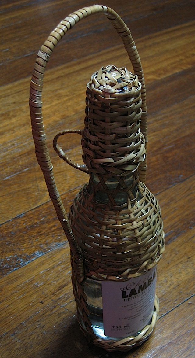 lambanog in a wicker bottle holder