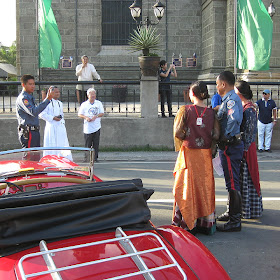 cop posing with costumed student-actors in Intramuros