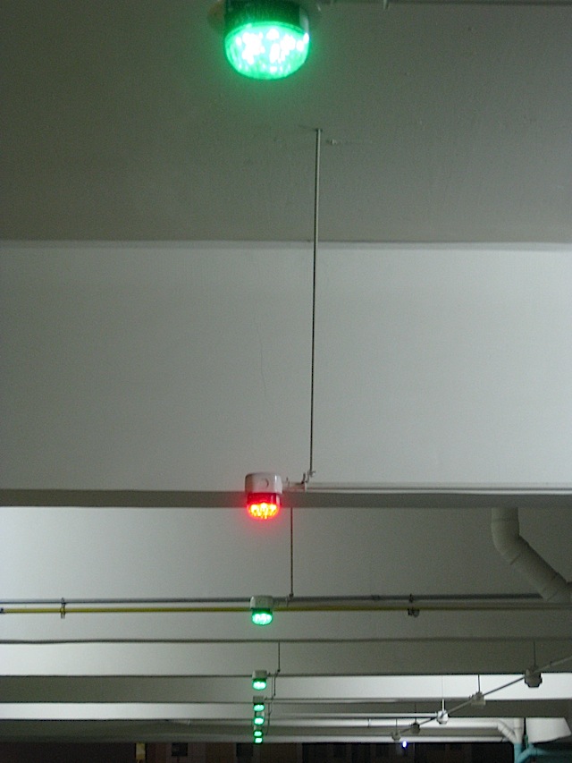 red and green lights in a parking building