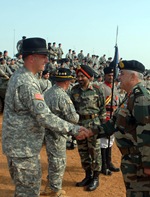 Indian army Maj. Gen. Anil Malik, general officer commanding, 31st Armored Division and keynote speaker at the opening ceremony for Exercise Yudh Abyas 09, greets U.S. Army Lt. Col. Jim Isenhower, commander, 2nd Squadron, 14th Cavalry Regiment, 2nd Stryker Brigade Combat Team, based in Schofield Barracks, Hawaii, at the opening ceremony for exercise Yudh Abhyas, at the Babina Indian army base, Oct. 12. YA09 is an annual bilateral exercise between the armies of India and the U.S. This year marks the first time in the history of the exercise in which two mechanized units participate.