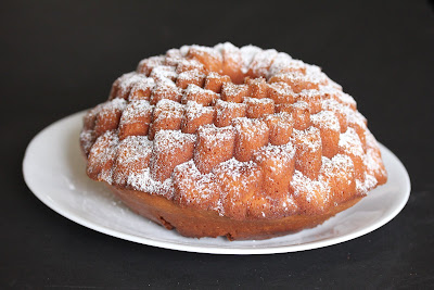 photo of a coconut tea cake dusted with powdered sugar