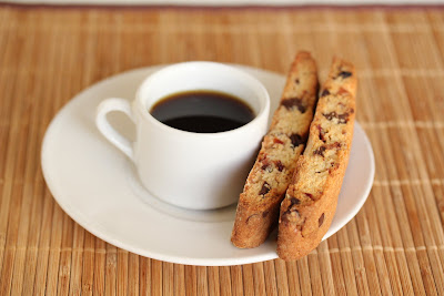 photo of a cup of coffee with biscotti