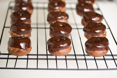 photo of mini chocolate cake donuts on a baking rack