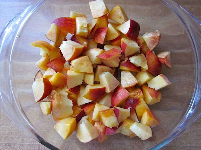 Top view of a bowl of diced peaches 