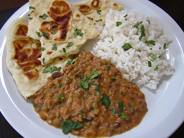 Dal Nirvana with naan and white rice plated on white plate 