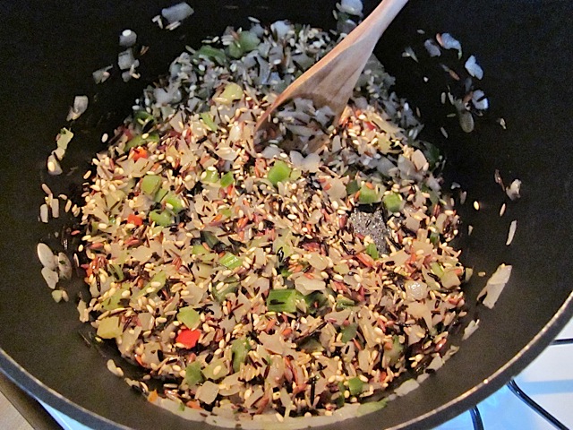 wild rice added to seasoning mix in pan to toast 