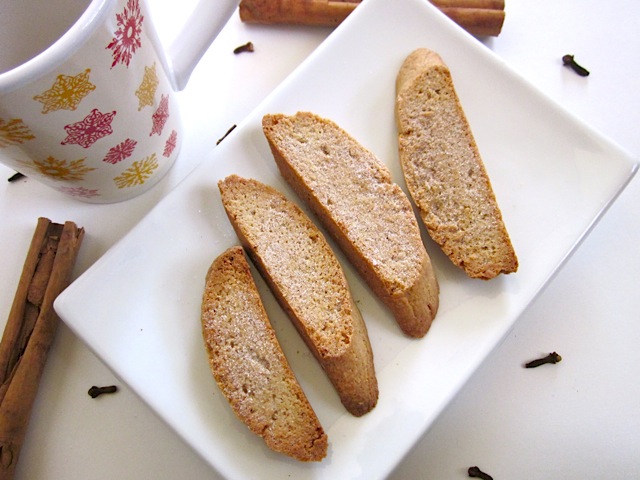 Cinnamon Spice Biscotti plated on white plat with cinnamon stick and mug next to it 