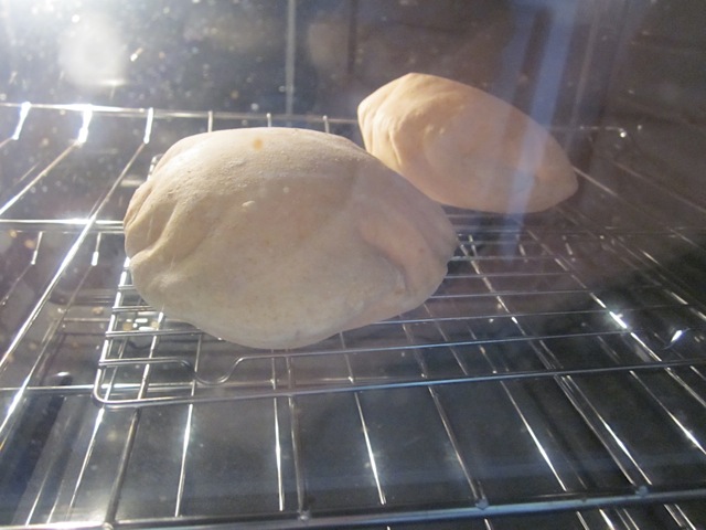 pita dough cooking inside oven (fully risen)