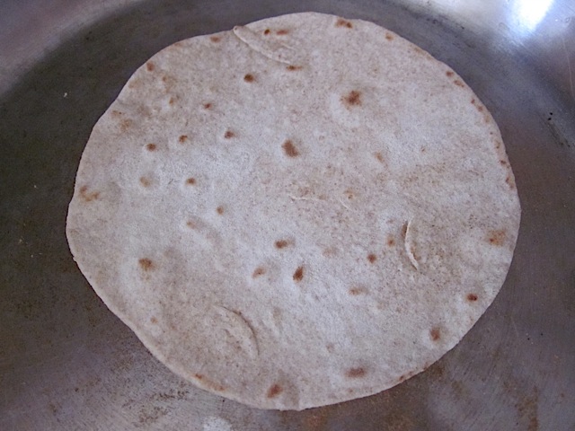 Cooking other side of tortilla in skillet 