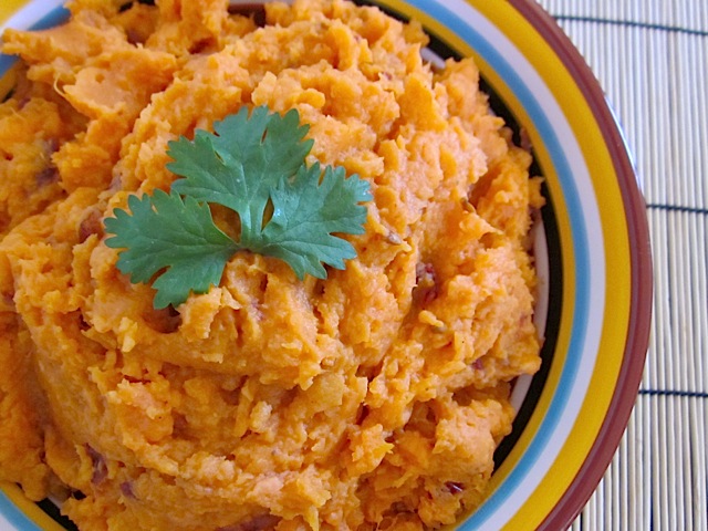 Top view of a bowl of chipotle mashed sweet potatoes garnished with parsley 
