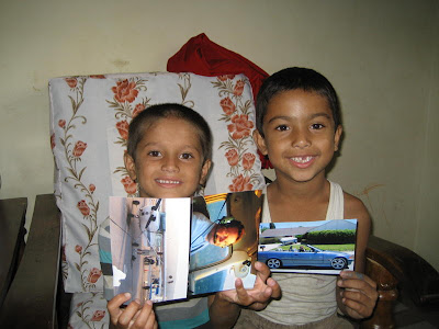 Ashis and Sudip with the photos I sent. In this shot, taken two years ago when I first met them, Ashish  and Sudip were both seven years old.