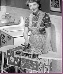 woman ironing in kitchen