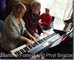 A study in concentration. Marlene Forrest (left) and Phyl Briscoe with a duet on the Clavinova whilst Ngaire Lonergan watches on.