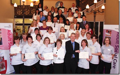 Sandra Shorter Head of Care4CE and Phil Lloyd Director of Adults, Community, Health and Wellbeing with Care4CE staff who were presented with achievement awards at Macclesfield Town Hall