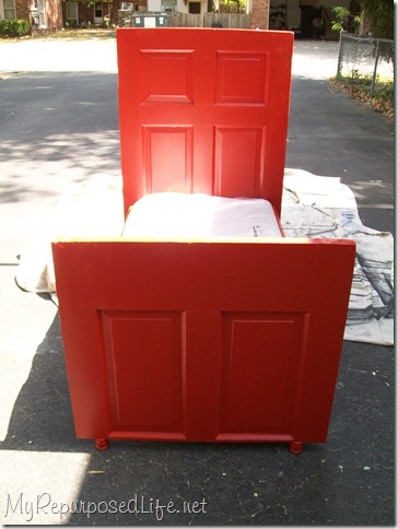 red toddler bed made from a door