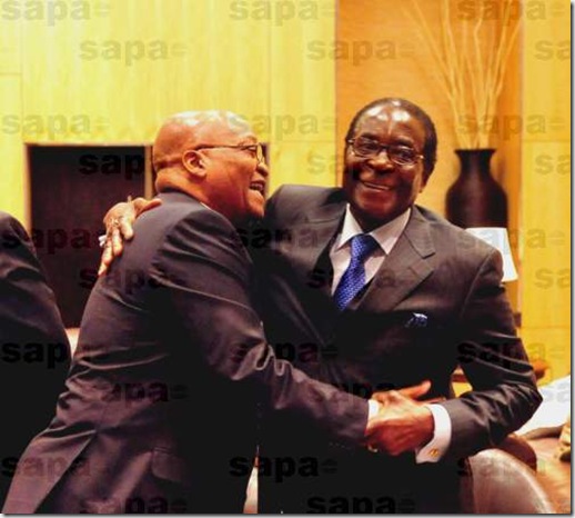 SA pres Zuma and Robert Zimbabwe embrace June 20 2009 SADC summit Joburg
