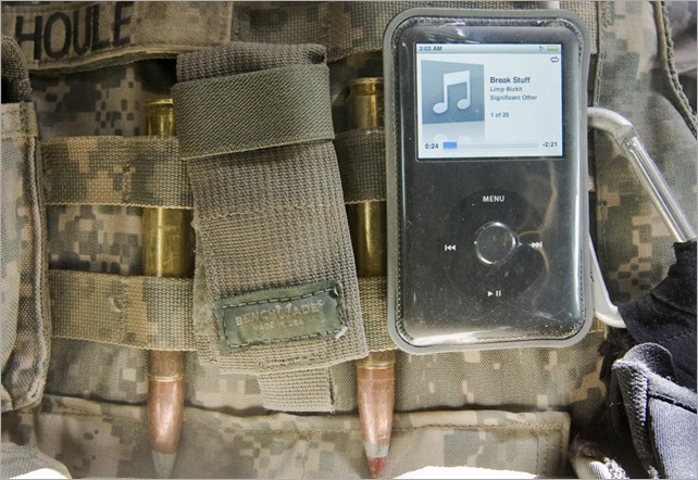 An iPod music player is attached to the tactical vest of a U.S. soldier of 3rd Platoon from the 3rd Brigade, 10th Mountain Division as he drives to the site of a roadside bomb explosion in the mountains of Wardak Province in Afghanistan July 11, 2009. (REUTERS/Shamil Zhumatov)