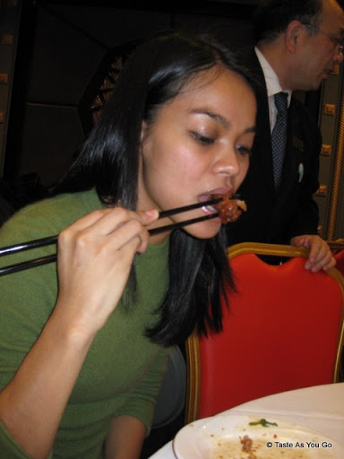 Michelle, Trying a Chicken Foot at Jing Fong Restaurant - Photo by Taste As You Go