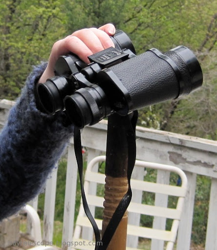 a pair of binoculars held on the end of a walking stick.