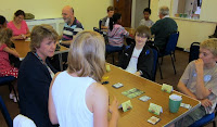 A photo showing a room full of gamers, with a game on Incan Gold in the foreground