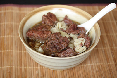 Beef noodle soup in a bowl with a spoon