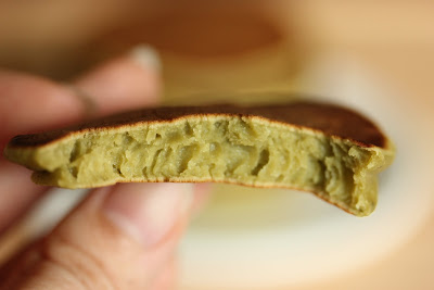 close-up photo of a matcha pancake with a bite taken out of it