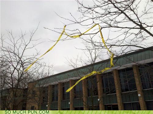 a funny pun with caution tape blown into trees: caution to the wind