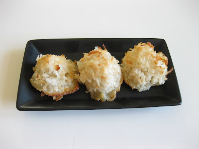 photo of three macaroons on a black plate