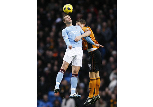 Edin Dzeko jumps with Christophe Berra, Manchester City - Wolverhampton Wanderers