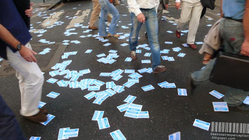 Feet Walking on Scattered Flyers in Buenos Aires, Argentina