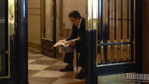 Concierge is Reading the Newspaper in the Entrance of a Residential Building in Buenos Aires, Argentina