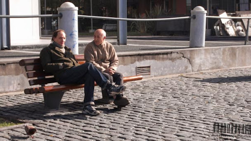 Argentinean Men Sitting on a Bench in Puerto Madero in Buenos Aires, Argentina