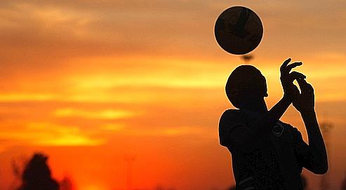 In this photo taken on June 2, 2010 South African kids play soccer in an open field in Soweto, South Africa. This week South Africa will be the center of the world. A democracy for just 16 years, the country will be thrust, ready or not, into the global spotlight when the 2010 World Cup kicks off Friday, June 11, 2010. South Africans know, and even if they didn't they wouldn't take long to realize. You can't go 20 meters without being reminded that global sport's biggest event is in town. The country's colorful flag flies everywhere, outside apartment buildings, office blocks, and on countless cars. (AP Photo/Hassan Ammar)