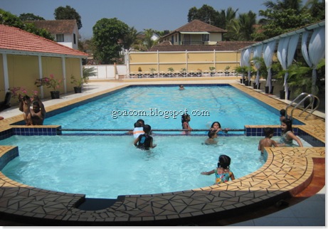 Goan families enjoying a swimming pool