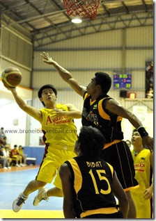 Soon Lee-Easyway's Lim Aik Hock (L) going for a layup over Sharks's Geve Leones yesterday. Picture: BT
