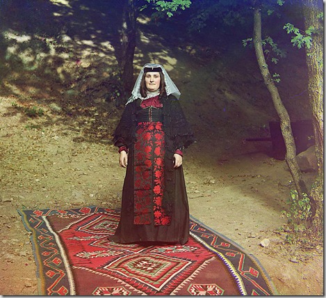 Georgian woman standing on a carpet, outside, near a tree; between 1905 and 1915
Sergei Mikhailovich Prokudin-Gorskii Collection (Library of Congress).