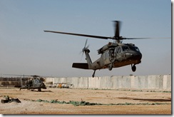 CAMP TAJI, Iraq – A Blackhawk and Apache attack helicopter from the 3rd and 4th Battalions, Combat Aviation Brigade, 4th Infantry Division, Multi-National Division – Baghdad, prepare to depart Camp Dolby recently on a combined air insertion operation six miles south of Baghdad. Soldiers from the CAB, the 1st Armored Div., and the Iraqi army conducted the operation as part of the ongoing air ground integration for MND-B aviators and Soldiers on the ground.
(U.S. Army photo by Sgt. 1st Class Brent Hunt, CAB PAO, 4th Inf. Div., MND-B)