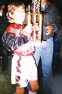 Lionel Messi aged seven recieves a trophy during a tournament in Balcarce