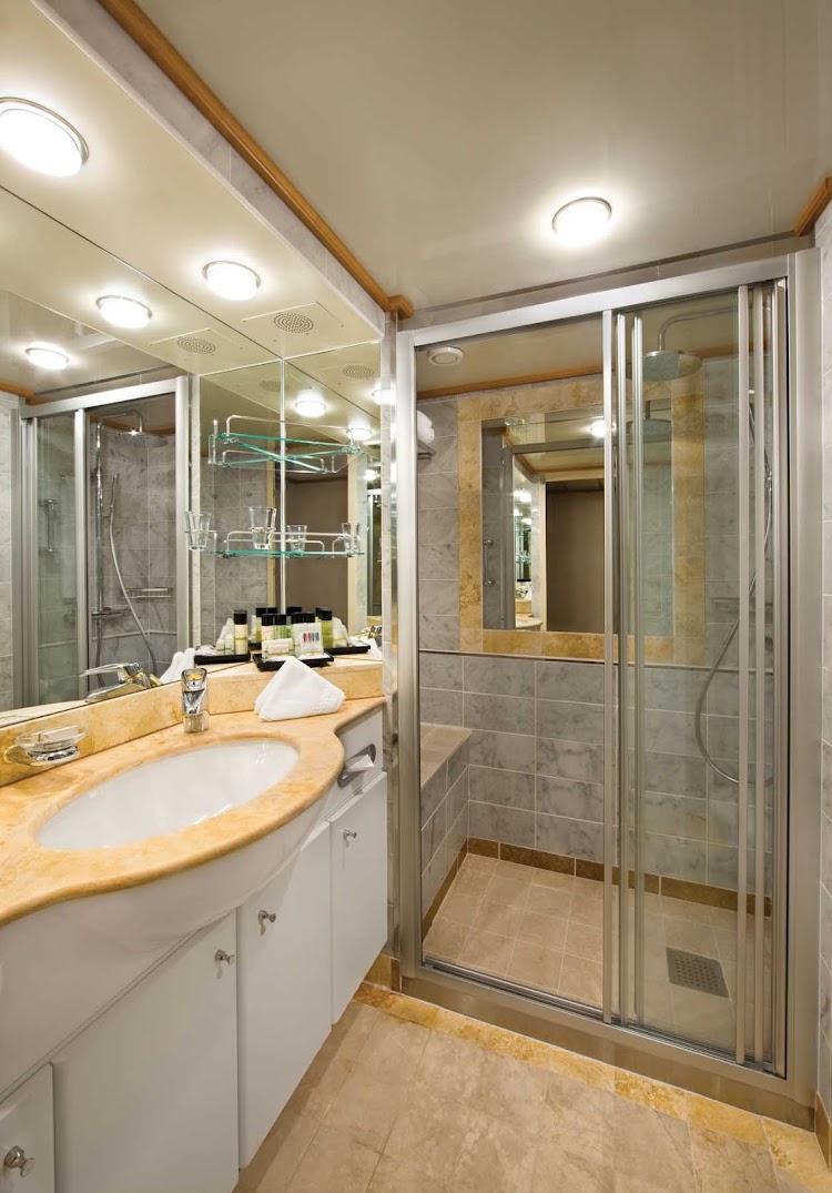 The classically designed marble bathroom you'll typically see in your stateroom aboard Seven Seas Mariner.