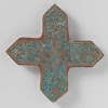 Tile in the shape of a cross with a bird among floral scrolls