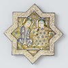 Tile in the shape of a star with two seated figures