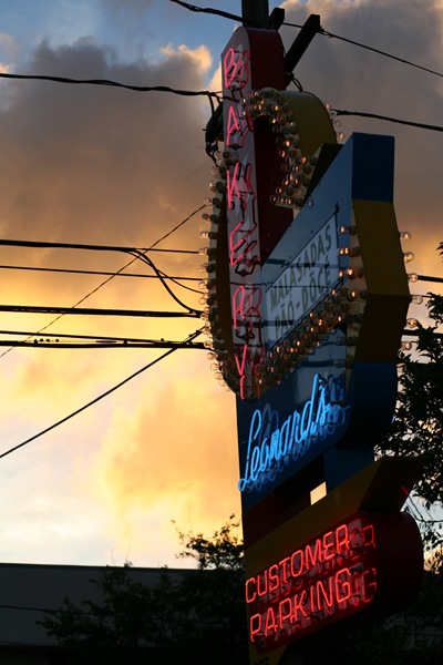 Leonard's Bakery malasadas neon sign at dusk