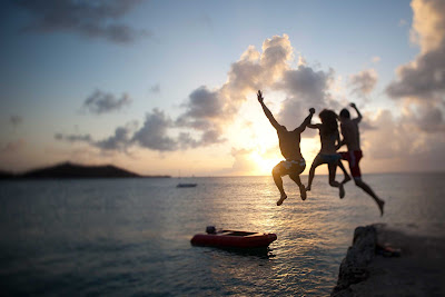 As the sun sets on St. Maarten, visitors take one last leap into the sea.