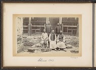 Chinese men and a boy in front of a house in Tibet