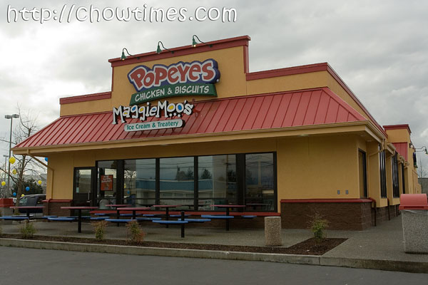  the distinctive yellow and red Popeyes Chicken and Biscuits restaurant.