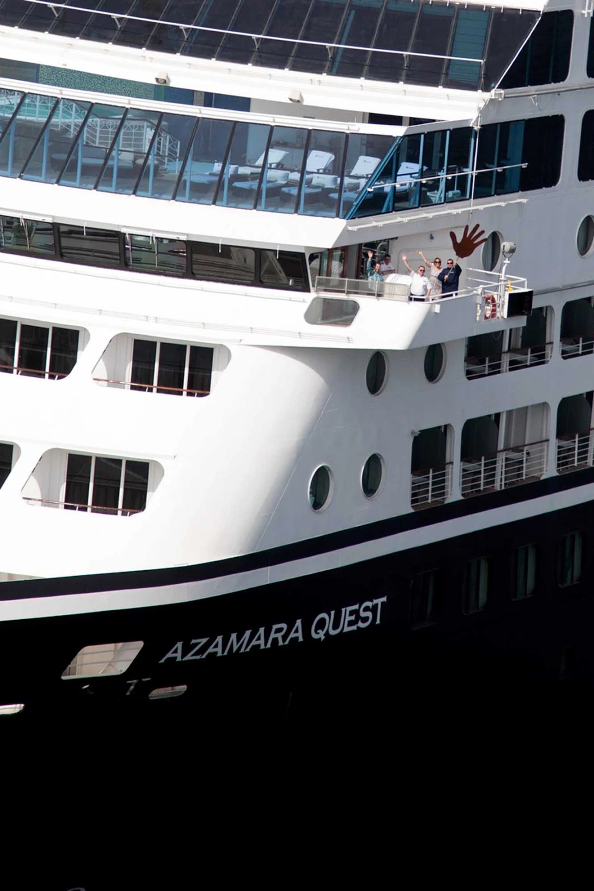 Azamara-Quest-closeup - Some friendly guests wave from the bow of Amamara Quest.